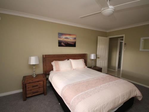 a bedroom with a large bed with two night stands at North Heaven Station in North Haven