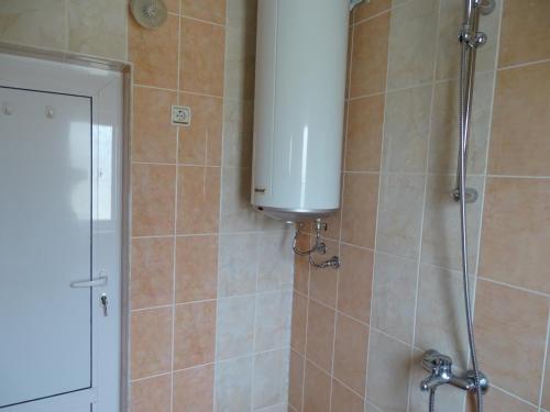a shower with a tank in a bathroom at Къща за гости - Софи, гр. Девин in Devin