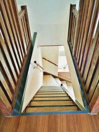 a staircase in a house with wooden railings at Müritzblick am Wünnow in Röbel