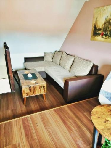 a living room with a couch and a coffee table at Müritzblick am Wünnow in Röbel