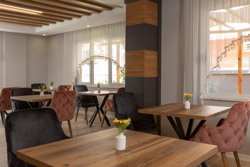 a dining room with wooden tables and chairs at Toprak Apart Otel in Antalya