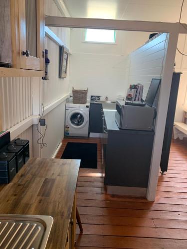 a kitchen with a washer and a washing machine at Evanston Station in Ilfracombe