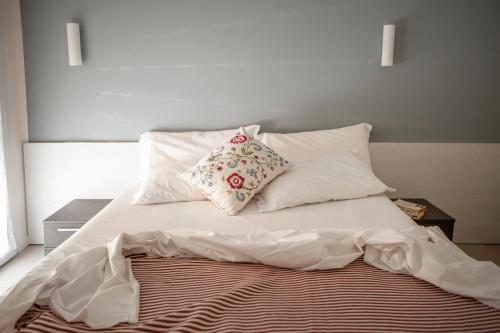 a bed with two pillows on top of it at Residence Sunrise in Cesenatico
