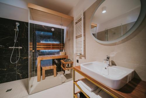 a bathroom with a sink and a shower and a mirror at Five Seasons Szklarska Poręba in Szklarska Poręba