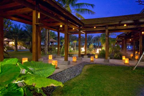 a pavilion with candles in a garden at night at Queena Plaza Hotel in Yongkang