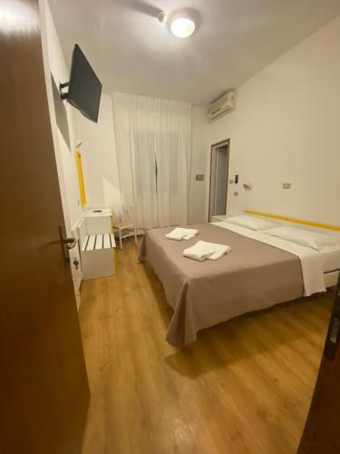a room with a bed with two towels on it at Hotel Neps in Lido di Jesolo