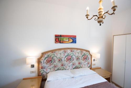 a bedroom with a bed with a floral headboard at Villa Moschella in Taormina