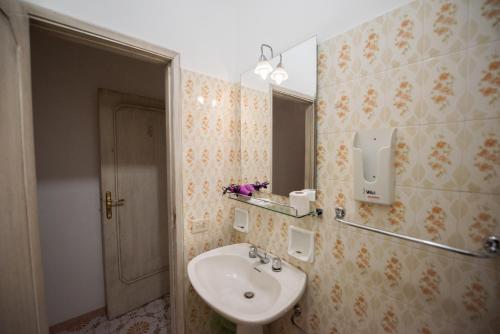 a bathroom with a sink and a mirror at Villa Moschella in Taormina