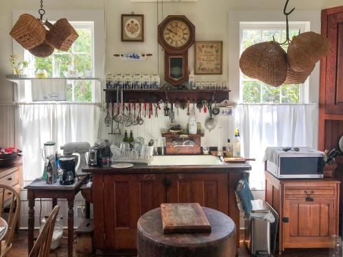 a kitchen with a counter with a sink and a clock at Yerba at Bastrop in Bastrop