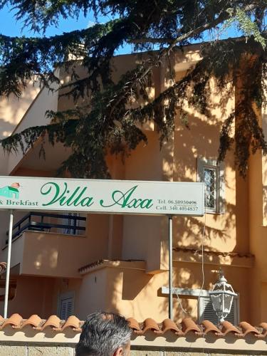 a man standing under a sign in front of a building at Villa Axa in Casal Palocco