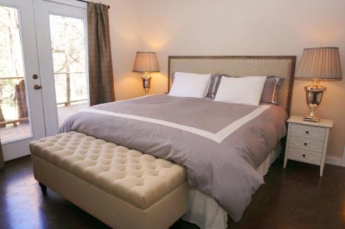 a bedroom with a large bed and a window at Deer Run- Creekhouse in Wimberley