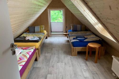 a room with two beds in a attic at Ferienhaus im Igelbau in Baabe