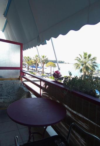 a table on a balcony with a view of the beach at Diamanto Rooms in Eretria