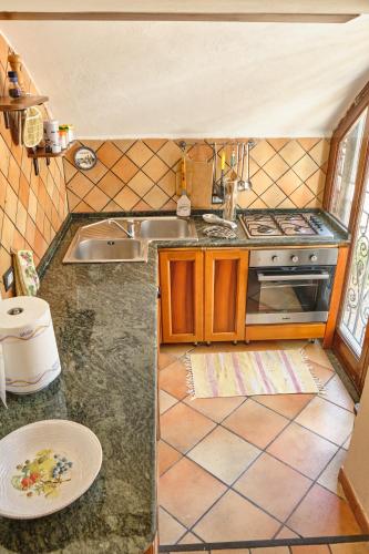 a small kitchen with a sink and a stove at Villa Santa Sofia - Italian Escape in Vico Equense