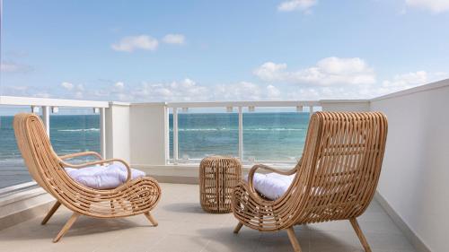 two chairs sitting on a balcony with a view of the ocean at Rivazzurra Homes - C in Termoli