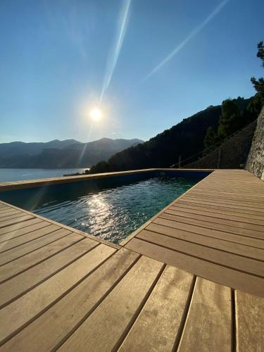 a swimming pool on a wooden deck with a view of the water at Villa Anna in Maiori