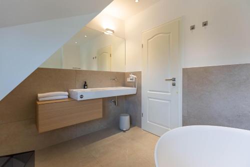 a bathroom with a sink and a mirror at Pur A4 in Wustrow