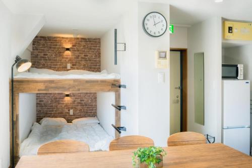a bedroom with a loft bed and a clock on the wall at Kumamoto - Apartment / Vacation STAY 81139 in Kumamoto