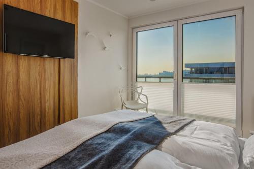 海利根港的住宿－Dat Penthus，卧室配有壁挂式平面电视