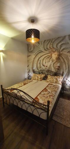 a bedroom with a bed with a wall mural at Apartma Archy in Moravske-Toplice