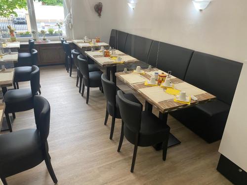 a row of tables and chairs in a restaurant at Pension Auszeit in Bad Neuenahr-Ahrweiler