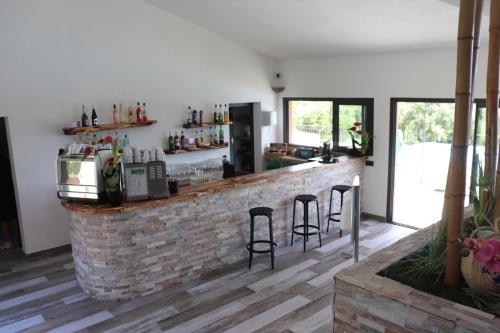 a kitchen with a brick bar with stools at Résidence U Pirellu in Porto-Vecchio