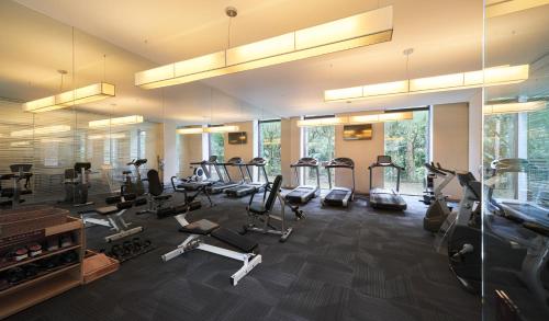 a gym with several treadmills and elliptical machines at Hotel Royal Chiao Hsi in Jiaoxi