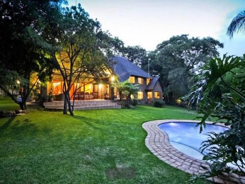 a house with a swimming pool in the yard at Shepherd Lodge in Johannesburg