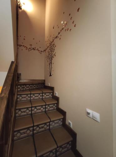 a set of stairs with birds flying in the air at LAS 4 ESTACIONES - Rascafría in Rascafría