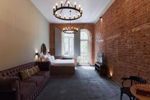 a living room with a couch and a brick wall at Sherwood Hotel in Rostov on Don