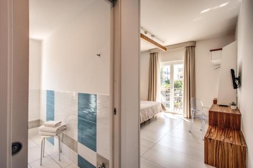 a room with a bedroom with a bed and a bathroom at Hotel Florida in Sorrento