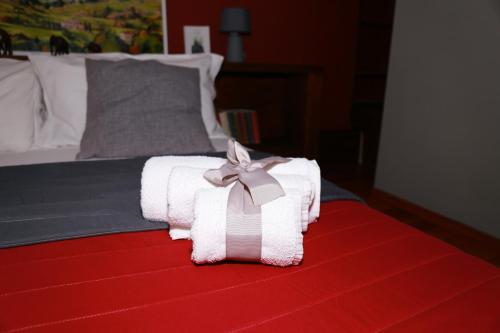 a bed with a white towel with a bow on it at La Casetta di Renato in Mormanno