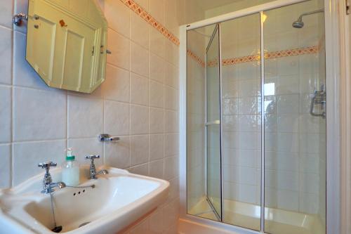 a bathroom with a sink and a shower at Hillcrest Luxury Apartment in Kilrush
