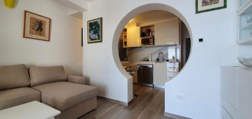 a living room with a couch and an archway at Pearl of Adriatic in Dubrovnik