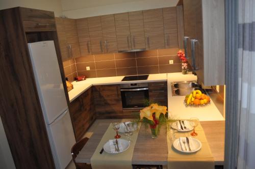 a kitchen with a table with plates of food on it at Liri's Apartments in Kalamaki
