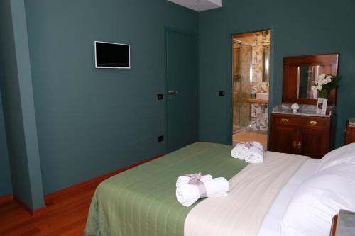 a bedroom with a bed with towels on it at La Casetta di Renato in Mormanno
