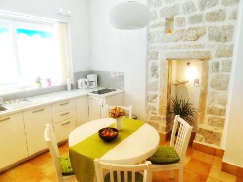 a kitchen and dining room with a table and chairs at Heart of the City Apartments in Dubrovnik