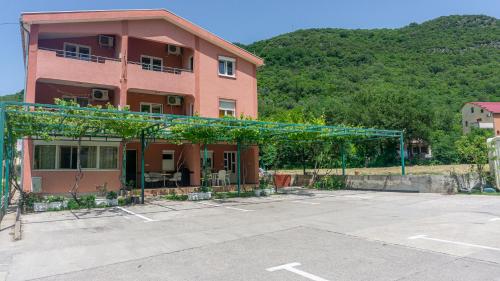 a building with a parking lot in front of it at Perfect Location close to Jaz beach - Apartments Rora Knezevic in Budva