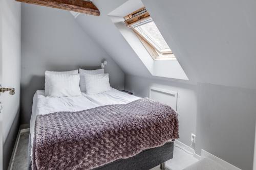 a bedroom with a bed in a attic at Cameo Boutique Hotell in Ystad