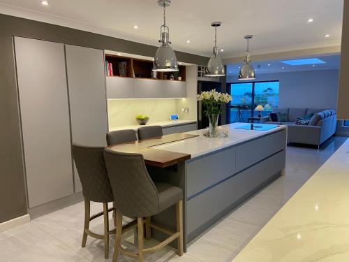 a kitchen with a island with a table and chairs at Cill Bhreac House B&B in Dingle