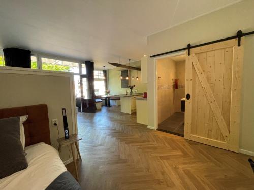 a room with a bed and a sliding barn door at Appartement "Hartje Haamstede" in Burgh Haamstede