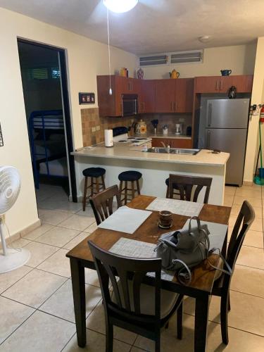 a kitchen with a table and chairs and a kitchen with a refrigerator at Boqueron vacation in Boqueron