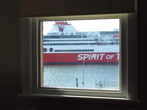 a window with a cruise ship in the water at The Formby Hotel in Devonport