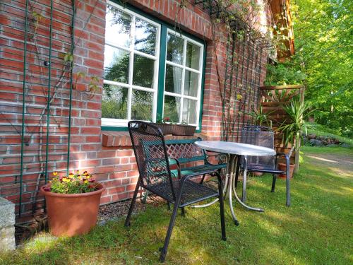 a table and chairs sitting next to a brick house at 4 Sterne-Haus am See in Waren