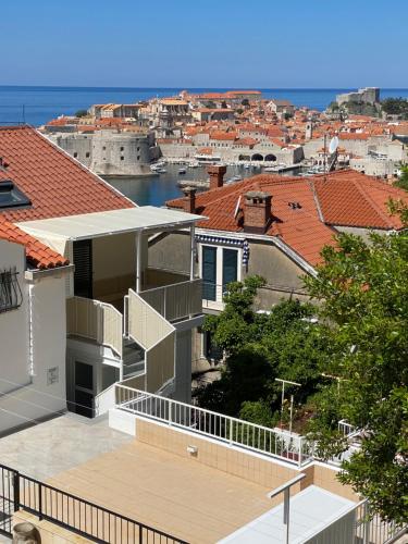a house with a balcony with a view of a city at Pearl of Adriatic in Dubrovnik