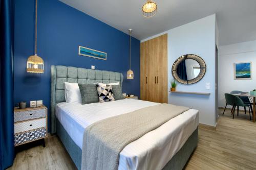 a blue bedroom with a large bed and a table at Villa Alexandra in Boukari