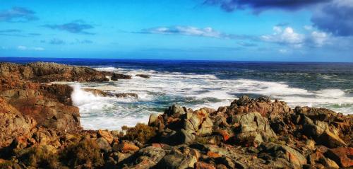 a view of the ocean from a rocky beach at 21 ON BAKOOND in Yzerfontein