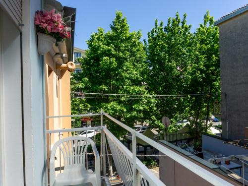 a balcony with a white railing and some trees at The 727 Sottomarina in Sottomarina