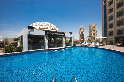 a large swimming pool in front of a building at Occidental Al Jaddaf, Dubai in Dubai