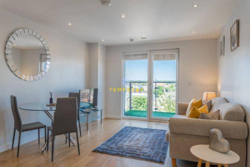 a living room with a couch and a table at 1BR Apt Near Heathrow By Tempstay in Slough